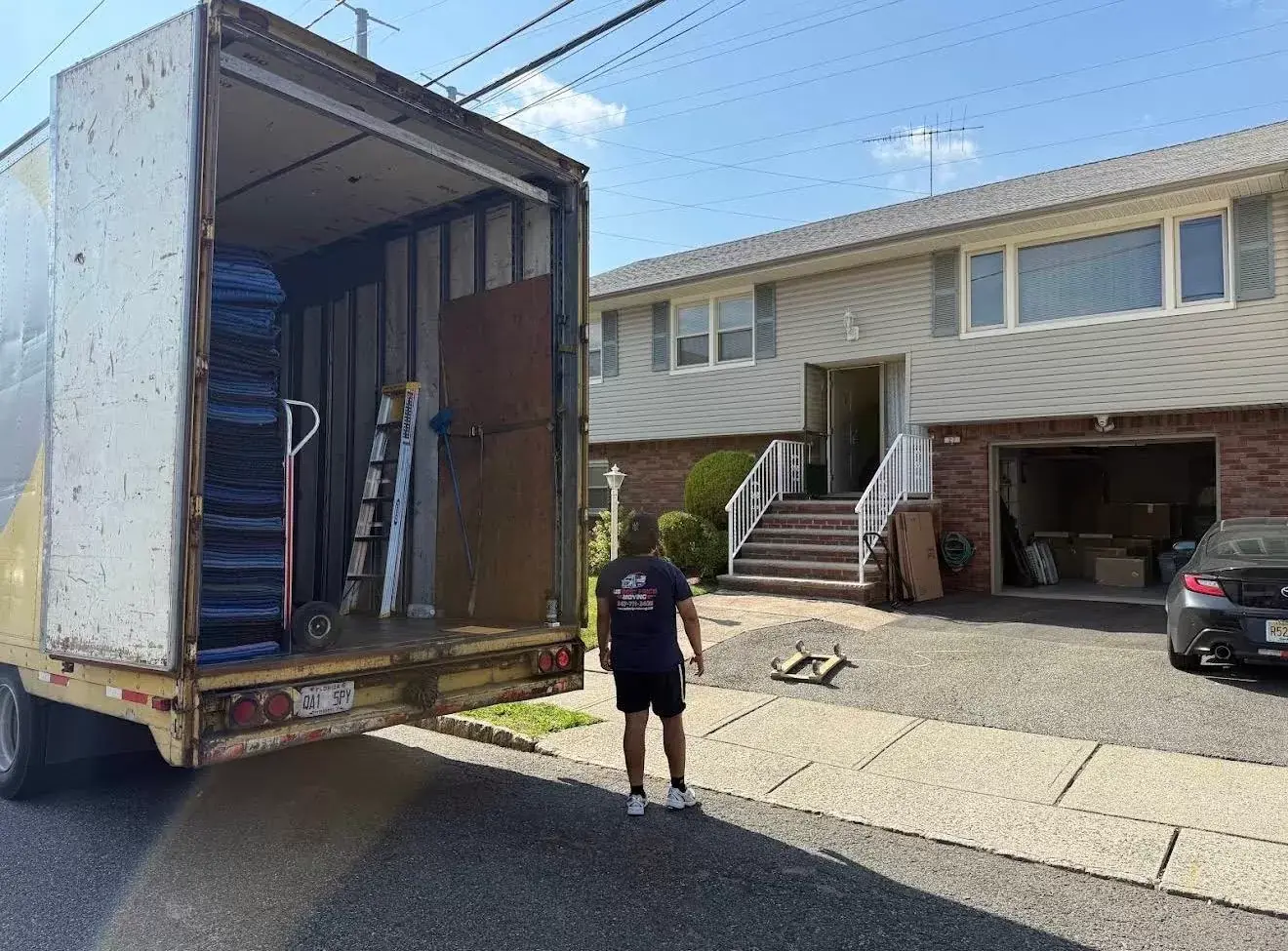 US Best Price Moving truck parked outside a New Jersey home, ready to load